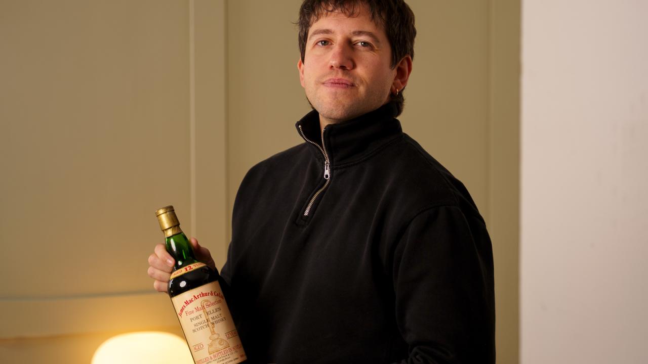 Head Curator Joe Wilson holding a bottle